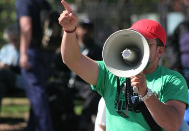 Protester pointing finger and holding megaphone