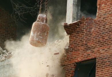 Action shot of a wrecking ball doing its work.