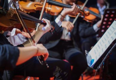 Violins playing in an orchestra