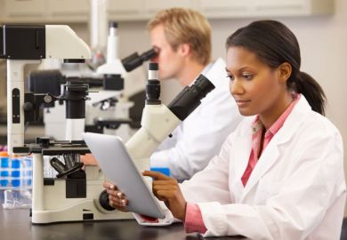 A black female scientist working in a lab A black female scientist working in a lab