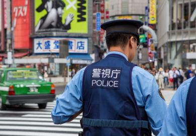 Japanese police presence at Shibuya Crossing, known as the scramble, the busiest pedestrian crossing in the world.