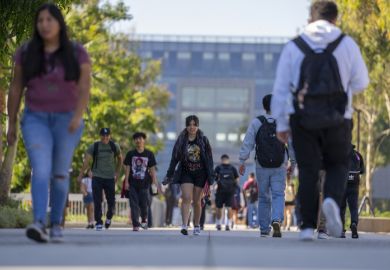 University students walk past the Natural Sciences and Mathematics build on the campus of Cal State University University students walk past the Natural Sciences and Mathematics build on the campus of Cal State University.