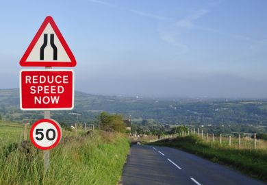 Sign on a road says 'reduce speed now'