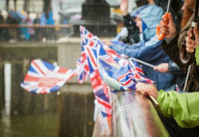 British people in heavy rain celebrating a parade