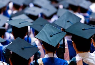 University graduates in graduation gowns and caps