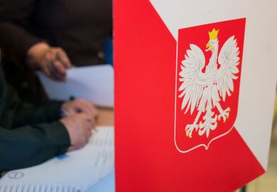 Person fills out ballot in Poland election