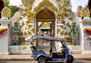 Tuk tuk in front of the entrance of Wat Chedi Luang, Chiang Mai, Thailand,