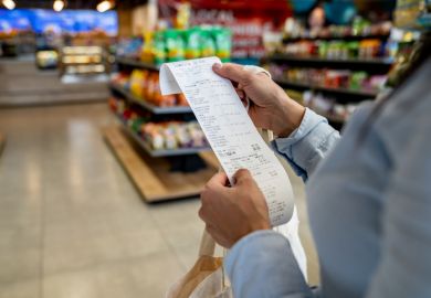 Woman shopping at a convenience store and checking her receipt Woman shopping at a convenience store and checking her receipt