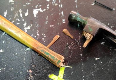 Close-Up Of Broken Hammer Handle On Table
