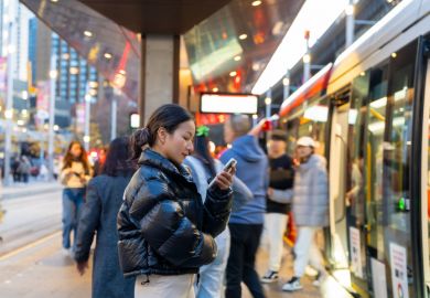 Businesswoman using mobile phone online working at train station Businesswoman using mobile phone online working at train station