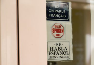 Sign reading 'Ici on parle francais; English spoken here; Se habla espanol'