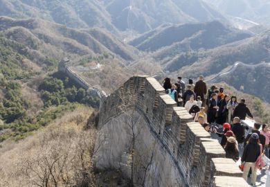 The Great Wall in Badaling with lots of visitors on a sunny day in autumn.