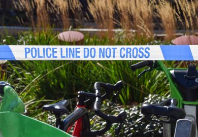 detail of police 'Do Not Cross' tape at a scene of an accident.