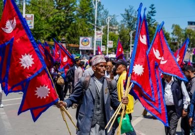 Pro-monarchy demonstrators waving national flags during a rally in Kathmandu, Nepal, in May 2025