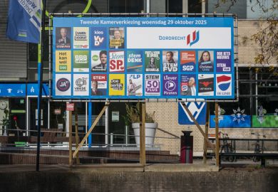 Dutch national election posters from various political parties displayed on a public board in Dordrecht