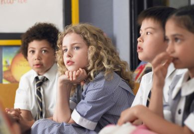 Thoughtful elementary students sitting in classroom Thoughtful elementary students sitting in classroom