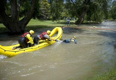 A rescue team readies to pull a mock victim to safety during a Swift Water Rescue training exercise.