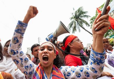 People in central Dhaka gather on the street to demonstrate for better workers rights in 2014.