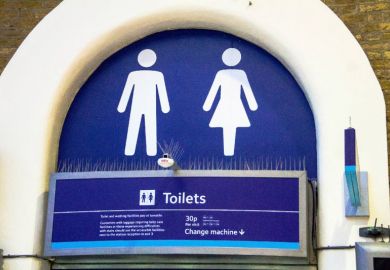 White lady and man toilet sign on blue background at Charing Cross railway station.
