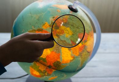 Globe under magnifying glass