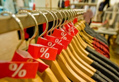 Rack of clothes with 0% tags on them Rack of clothes with 0% tags on them