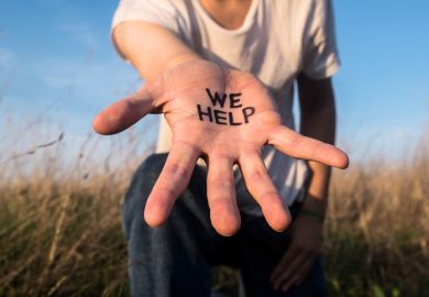 Extended hand with “We help” on the palm Extended hand with “We help” on the palm, illustrating assistance to international students
