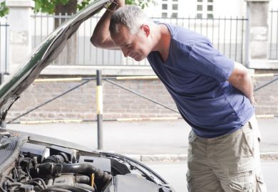 Inspection, man looking under car bonnet 