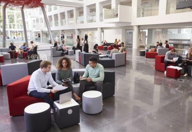 Students sitting in a university atrium Students sitting in a university atrium