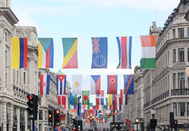 A number of different national flags are displayed above a London street A number of different national flags are displayed above a London street