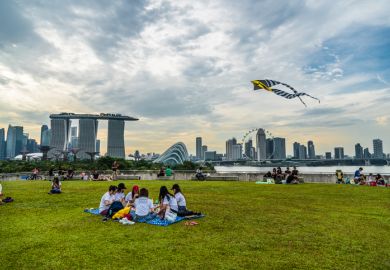 Singapore - 1 October 2016: People enjoying their weekend with different activities at the rooftop of Marina barrage. Singapore - 1 October 2016: People enjoying their weekend with different activities at the rooftop of Marina barrage.