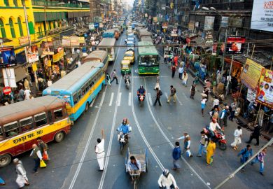 Pedestrians cross the road in front of motorcycles, cars and buses at the crossroads on January 20, 2013 in India. Pedestrians cross the road in front of motorcycles, cars and buses at the crossroads on January 20, 2013 in India.