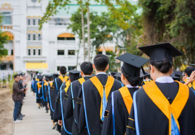 Back of graduates during commencement at university.