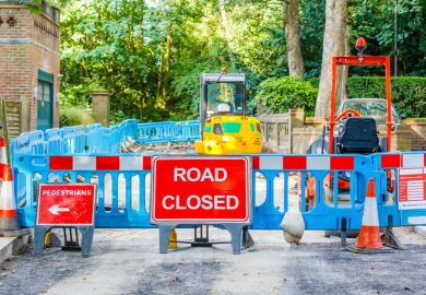 In front of roadworks a sign says 'Road closed' In front of roadworks a sign says 'Road closed'