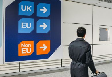 Passenger walks past sign prior to immigration control pass a sign pointing towards queues for UK, EU and Non-EU passport holders. Passenger walks past sign prior to immigration control pass a sign pointing towards queues for UK, EU and Non-EU passport holders.