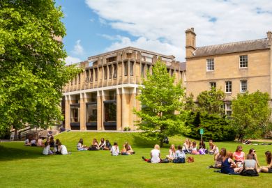 Students relaxing on the grass outside Balliol College of Oxford University