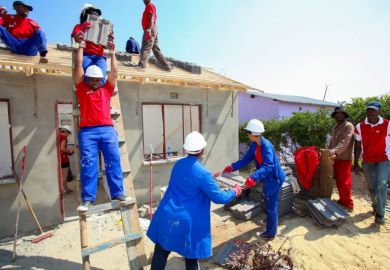 Community members building a low cost house as a team in Soweto. Community members building a low cost house as a team in Soweto.