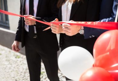 Close-up Of Businesspeople Hand Cutting Red Ribbon With Scissors Close-up Of Businesspeople Hand Cutting Red Ribbon With Scissors