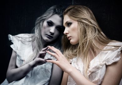 A woman looking at herself in the mirror