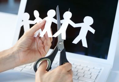 Someone cuts some human figures out of paper Someone cuts some human figures out of paper