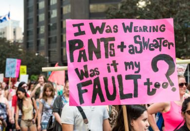 A protest sign reading "I was wearing pants + a sweater, was it my fault too?" Taken during "Slut Walk 2012" in Toronto.