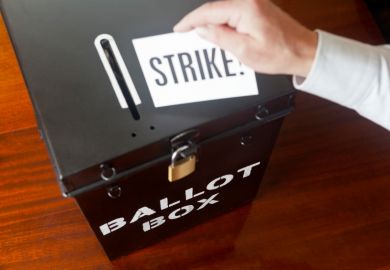 man placing strike ballot card into box