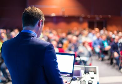 Speaker giving presentation at conference