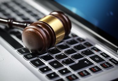 Judge's gavel on computer keyboard