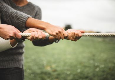 Two people taking part in a tug of war