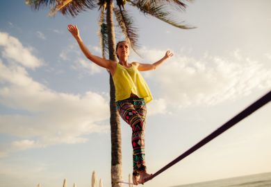 Teenage girl balancing on slack line