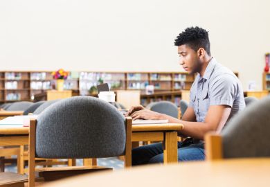 Black student in university library Black student in university library