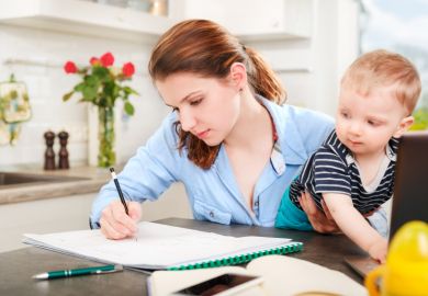 Student mother working with baby Student mother working with baby