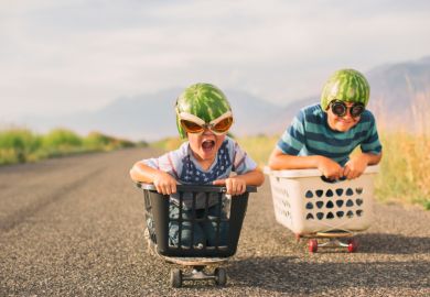 Young boys racing wearing watermelon helmets