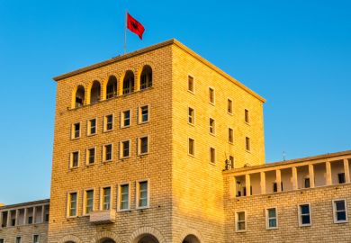 The Albanian flag flies above the Polytechnic University of Tirana