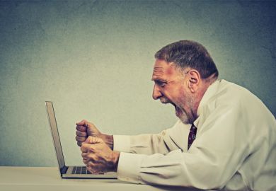 Angry man shouting at computer Angry man shouting at computer